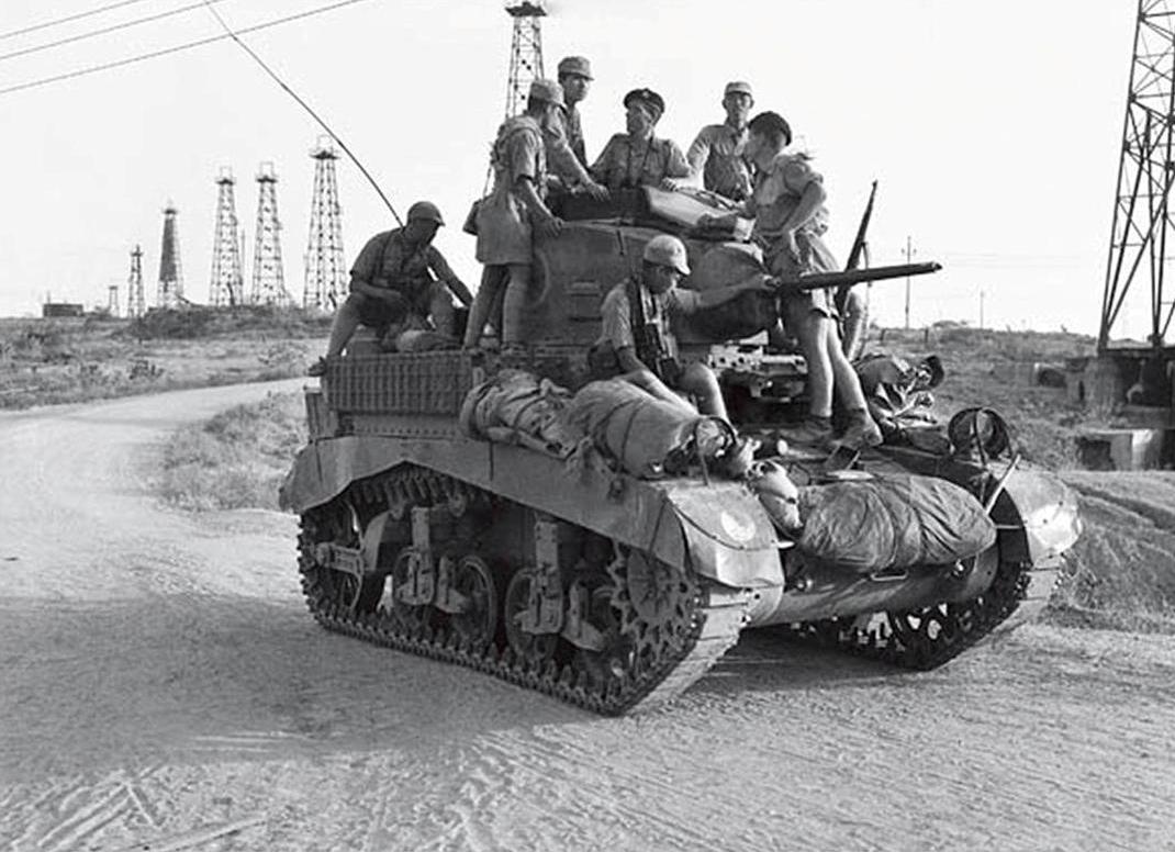British and Chinese troops on a British M3 Stuart tank after Chinese troops relieved 7,000 British troops who had been surrounded by the Japanese in the Battle of Yenangyaung, Burma (now Myanmar), 19 Apr 1942
