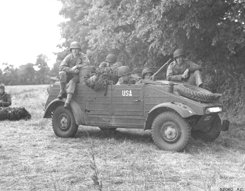 US Army troops in a captured Kübelwagen in France, 1945. Note that the censors have removed the front bumper markings.