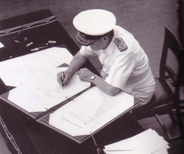 Admiral Sir Bruce Fraser signing the surrender instrument on behalf of the United Kingdom aboard USS Missouri, Tokyo Bay, Japan, 2 Sep 1945, photo 3 of 3