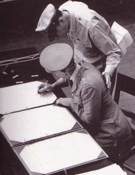 Colonel Lawrence Cosgrave signing the surrender instrument on behalf of the Dominion of Canada aboard USS Missouri, Tokyo Bay, Japan, 2 Sep 1945.