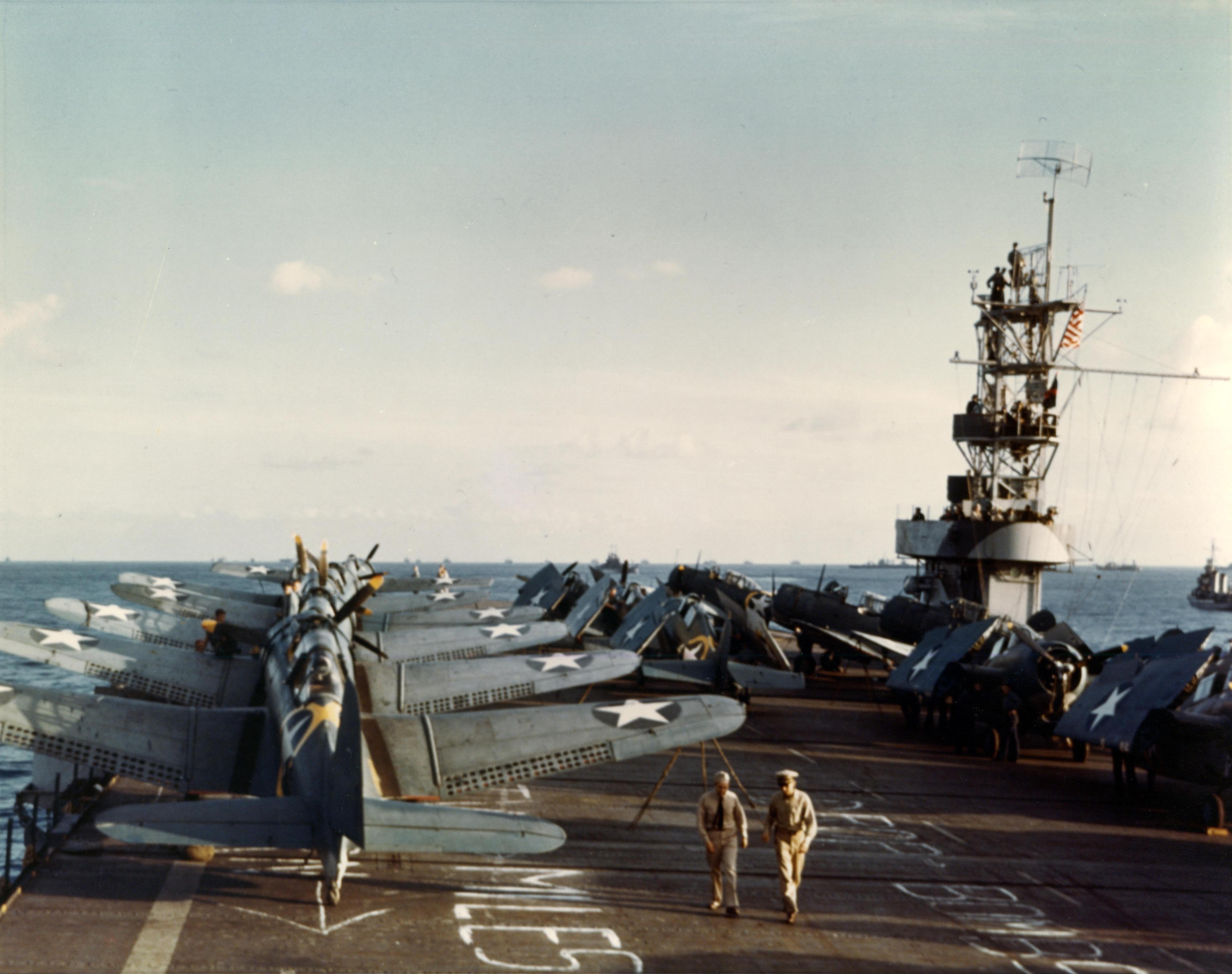 Flight deck of the USS Santee filled with SBD-3 Dauntless scout-bombers and F4F-4 Wildcat fighters bound for Operation Torch in North Africa, Nov 1942. Note target and distance information chalked on the flight deck.