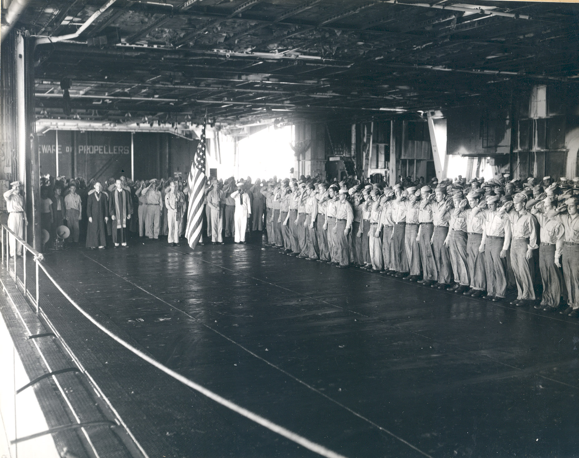 A burial party assembled on Intrepid's hangar deck in the Philippine Sea the day following the special attack of 25 Nov 1944, photo 1 of 5