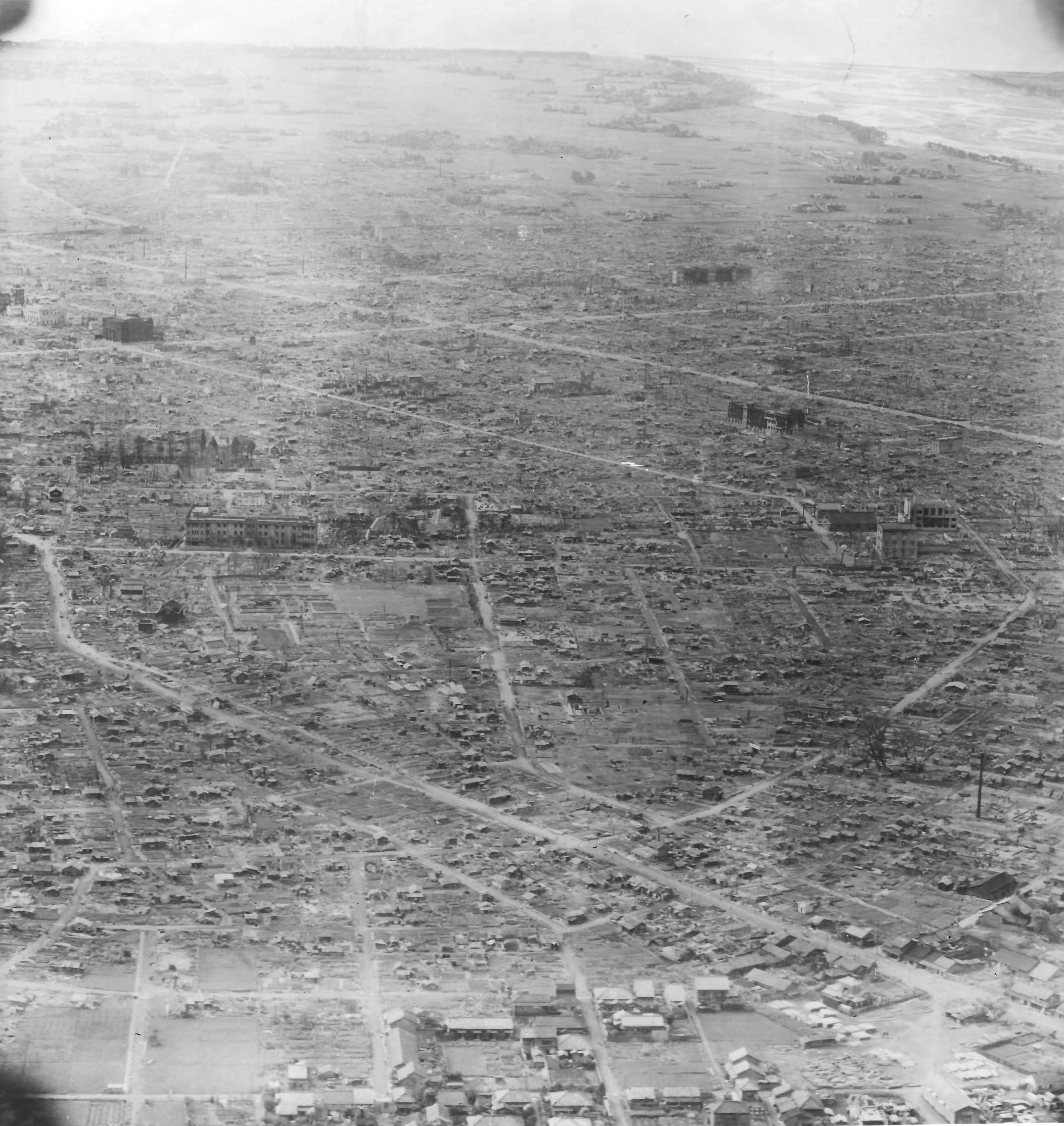 Aerial photo taken from aircraft from the USS Wasp (Essex-class) showing the near complete destruction of the Japanese city of Nagoya, late Aug 1945