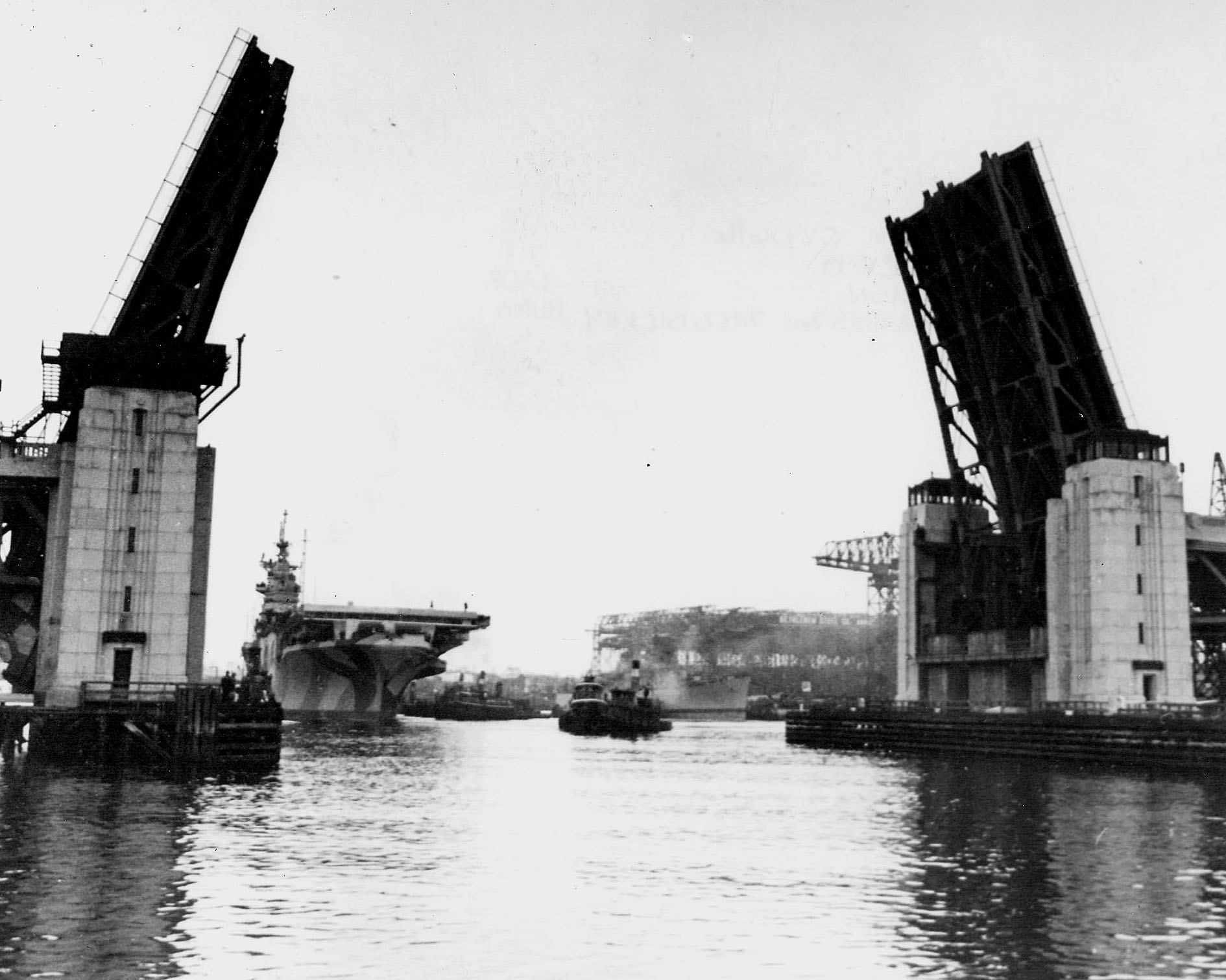 Essex-class Aircraft Carrier Hancock moving past the Fore River Bridge, Quincy, Massachusetts, United States, 14 Apr 1944, the day before her commissioning. Photo 1 of 2