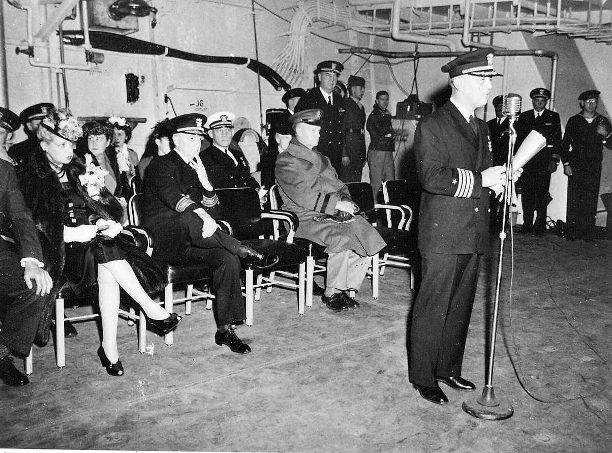 Captain Fred C Dickey taking command at the commissioning of USS Hancock, Navy Yard Annex, South Boston, 15 Apr 1944. Note Commandant First Naval District RearAdm Robert Theobald seated behind Dickey.