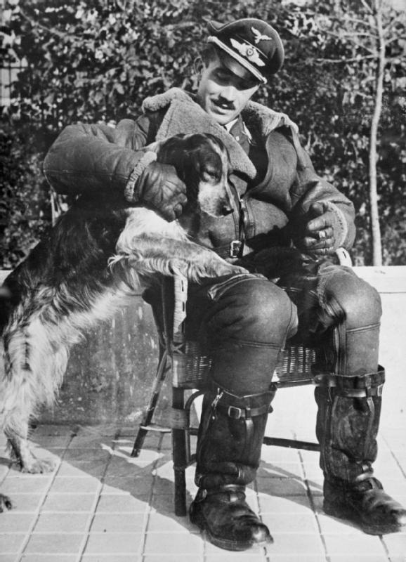 Adolf Galland in his flying gear with his dog, ‘Schweinebauch’ (Pork Belly), Audembert, France 1940.