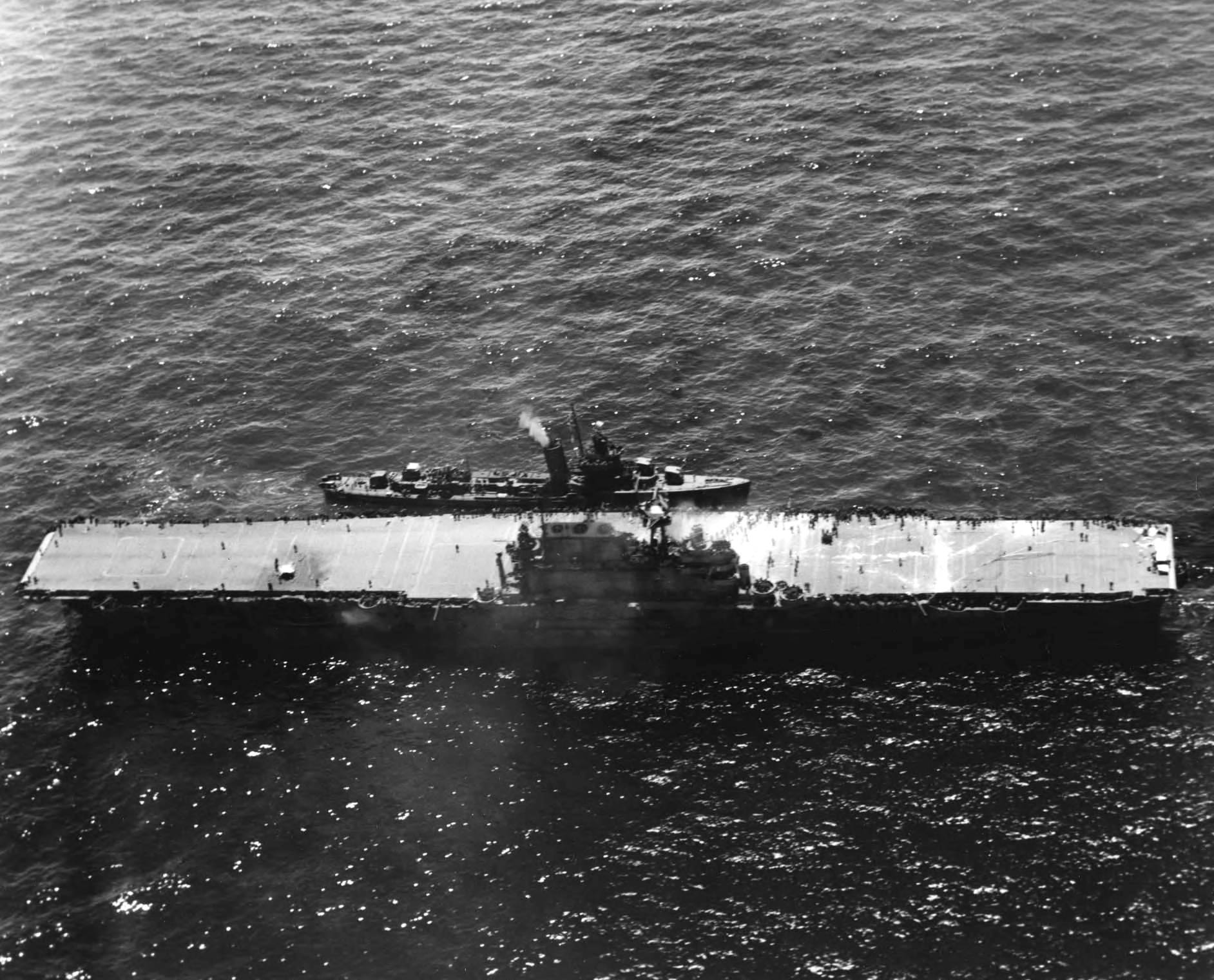 Destroyer USS Russell coming alongside the stricken USS Hornet (Yorktown-class) in one of the last photographs of the carrier before she was scuttled, Battle of Santa Cruz Islands, 26 Oct 1942.