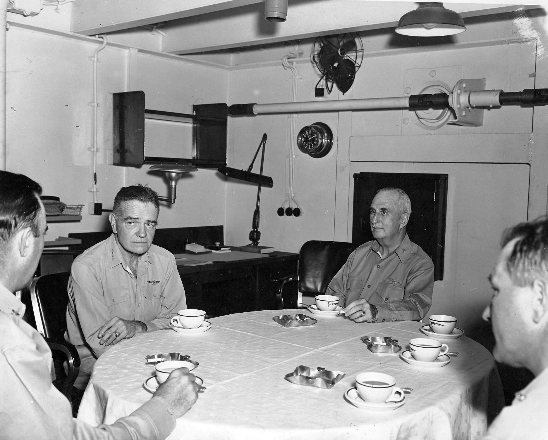 Admiral Halsey, Rear Admiral Charles P Mason, Captain Austin K Doyle, and an unidentified captain in the captain's cabin on USS Nassau at Nouméa, New Caledonia, 23 Dec 1942