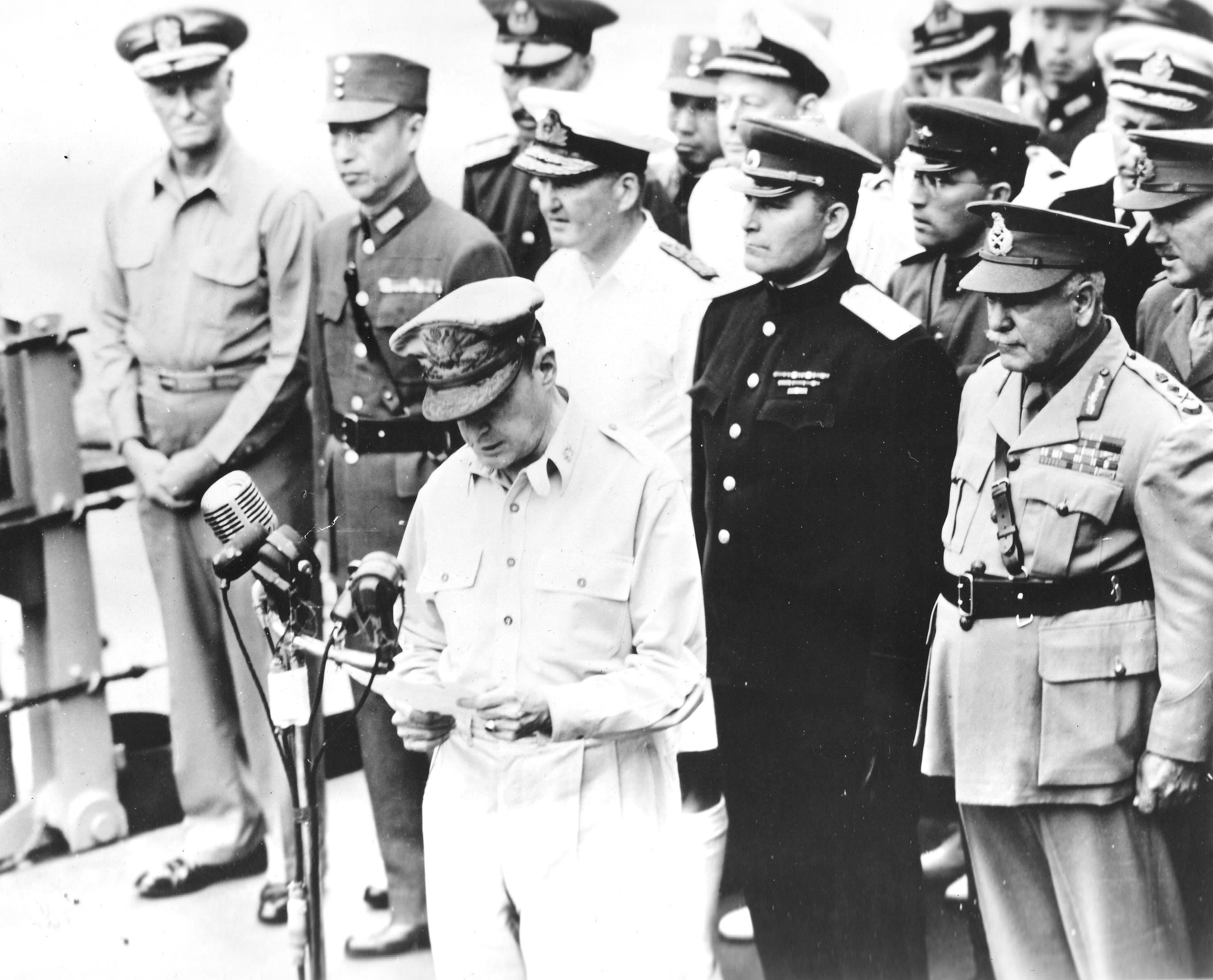 Chester Nimitz, Xu Yongchang, Bruce Fraser, Kuzma Derevyanko, and Thomas Blamey behind Douglas MacArthur aboard USS Missouri during the surrender ceremony, Tokyo Bay, Japan, 2 Sep 1945.