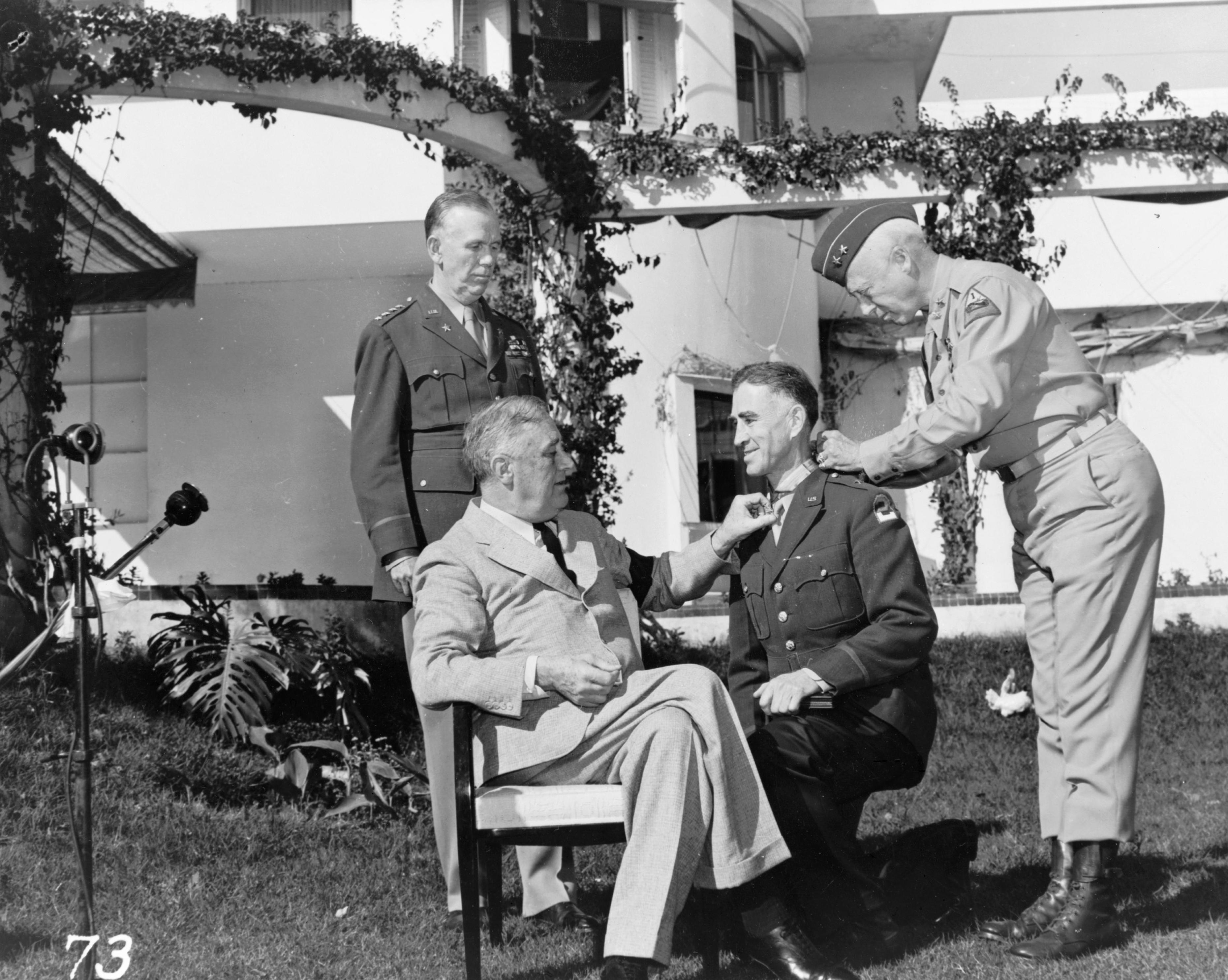 Franklin Roosevelt awarding Brigadier General William Wilbur the Medal of Honor, Casablanca, French Morocco, 22 Jan 1943; note George Marshall in background and George Patton assisting. Photo 2 of 2.