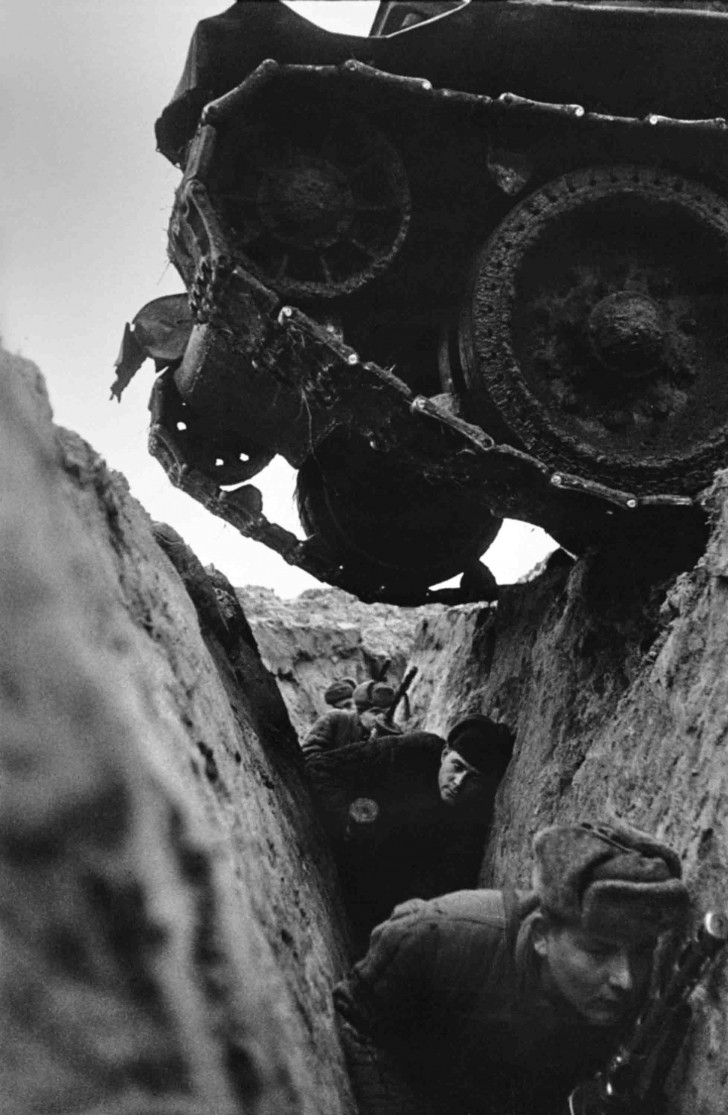 Soviet infantrymen in a trench while a T-34 tank passed over them, date unknown