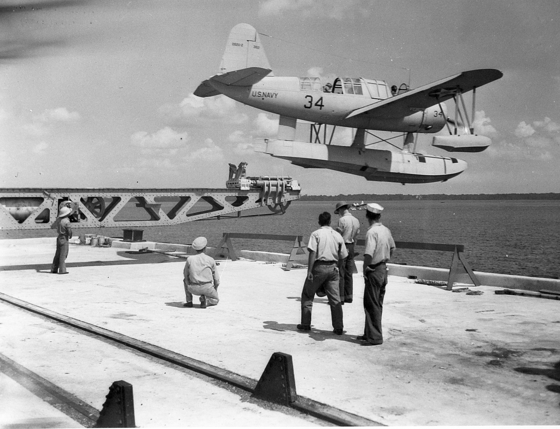 OS2U Kingfisher float plane being shot off a catapult mounted on a dock for training purposes at Pensacola, Florida, United States, pre-war 1941.
