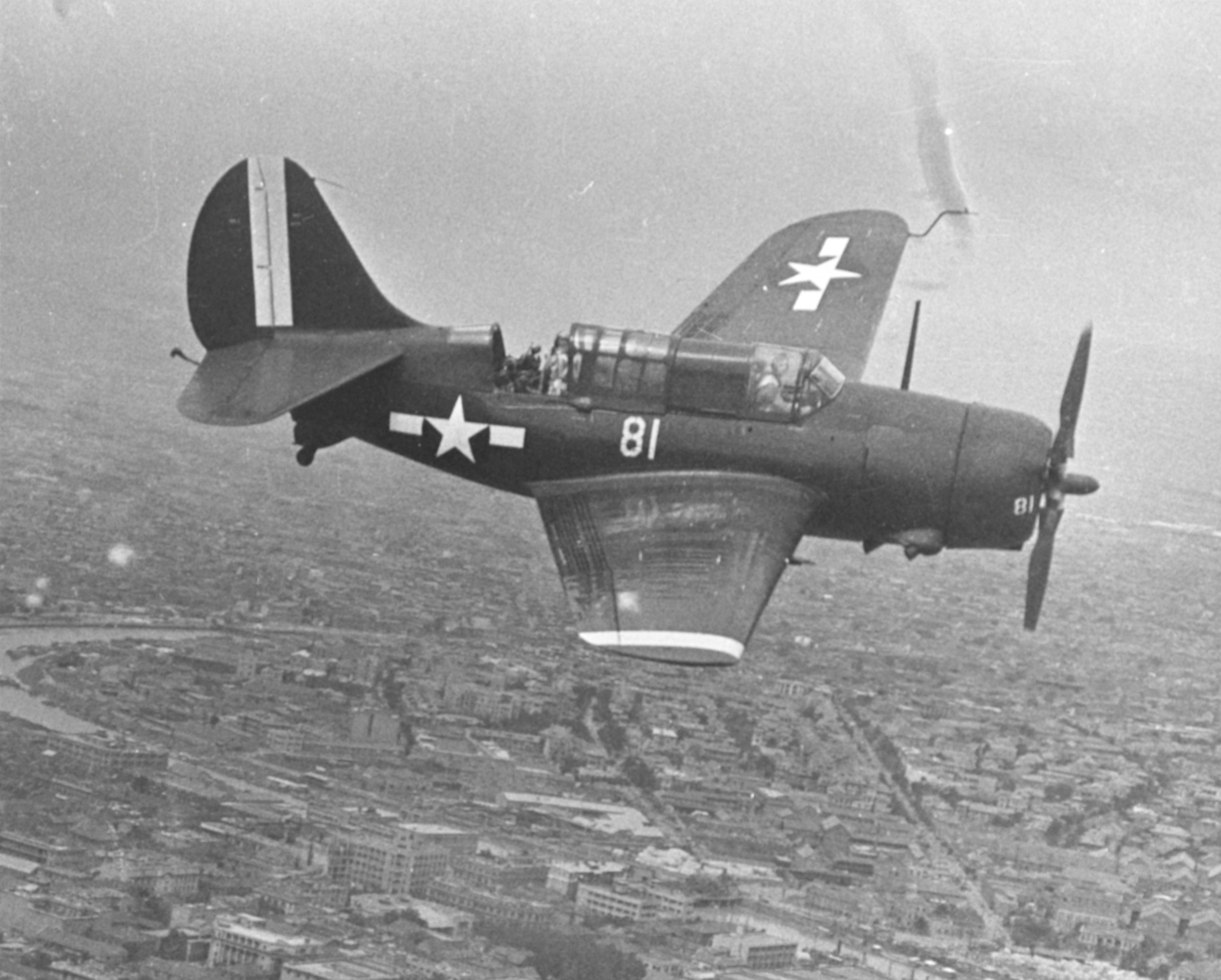 A Curtis SB2C Helldiver flying from USS Intrepid over Tientsin, China (now Tianjin), 5 Sep 1945. Intrepid launched 86 aircraft this day as a show of strength during the demobilization of Japanese forces in the area.