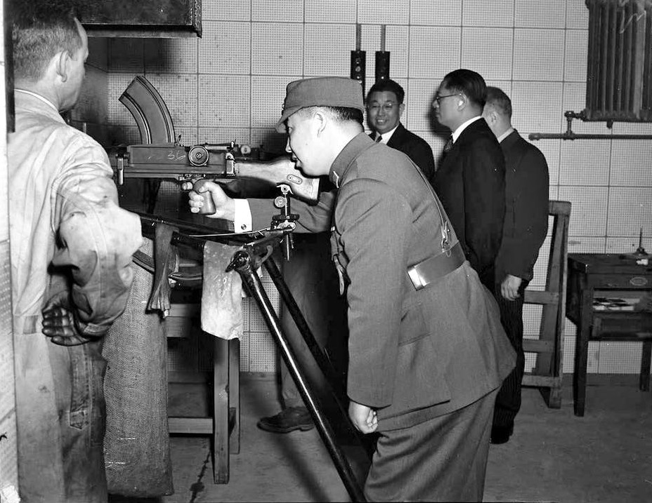 Chinese representatives studying a Bren gun at the John Inglis and Company factory, Toronto, Canada, 20 Aug 1943
