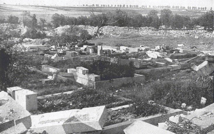 Lidice, Czechoslovakia 10 Jun 1942. The village cemetery with all graves open and the headstones broken up.