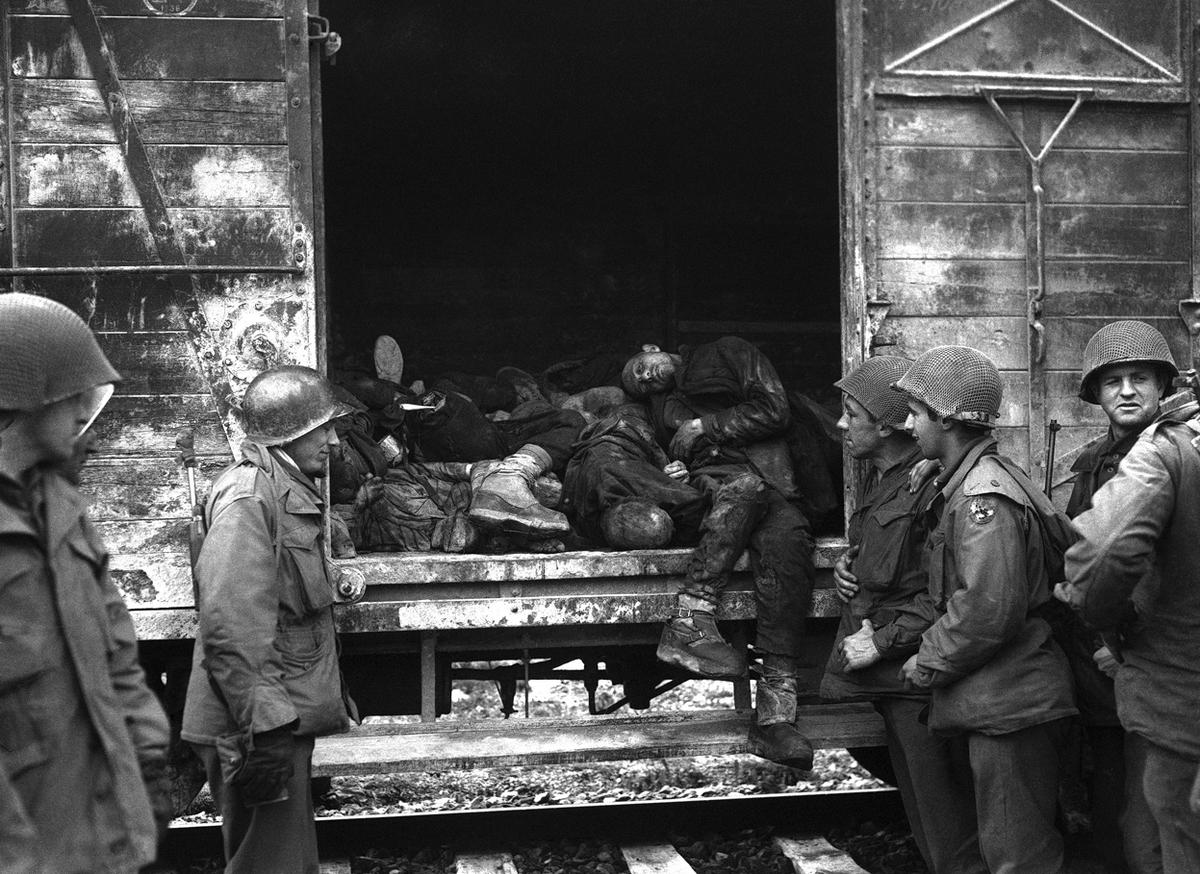 After liberating Dachau concentration camp, members of the US 42nd Division inspecting a railroad carriage full of dead prisoners, May 1945.