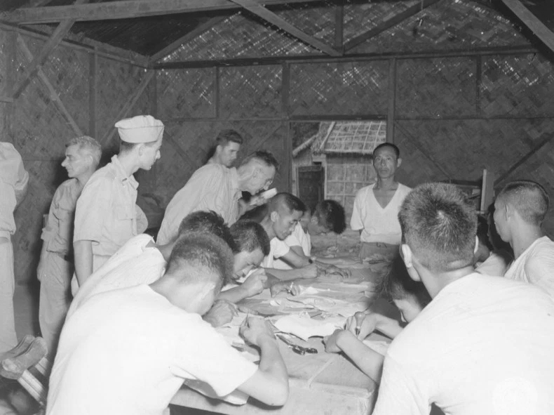 Lieutenant General Joseph Stilwell observing leather work class attended by wounded Chinese soldiers at a rehabilitation center along the Ledo Road in Assam, India, 15 Jul 1944
