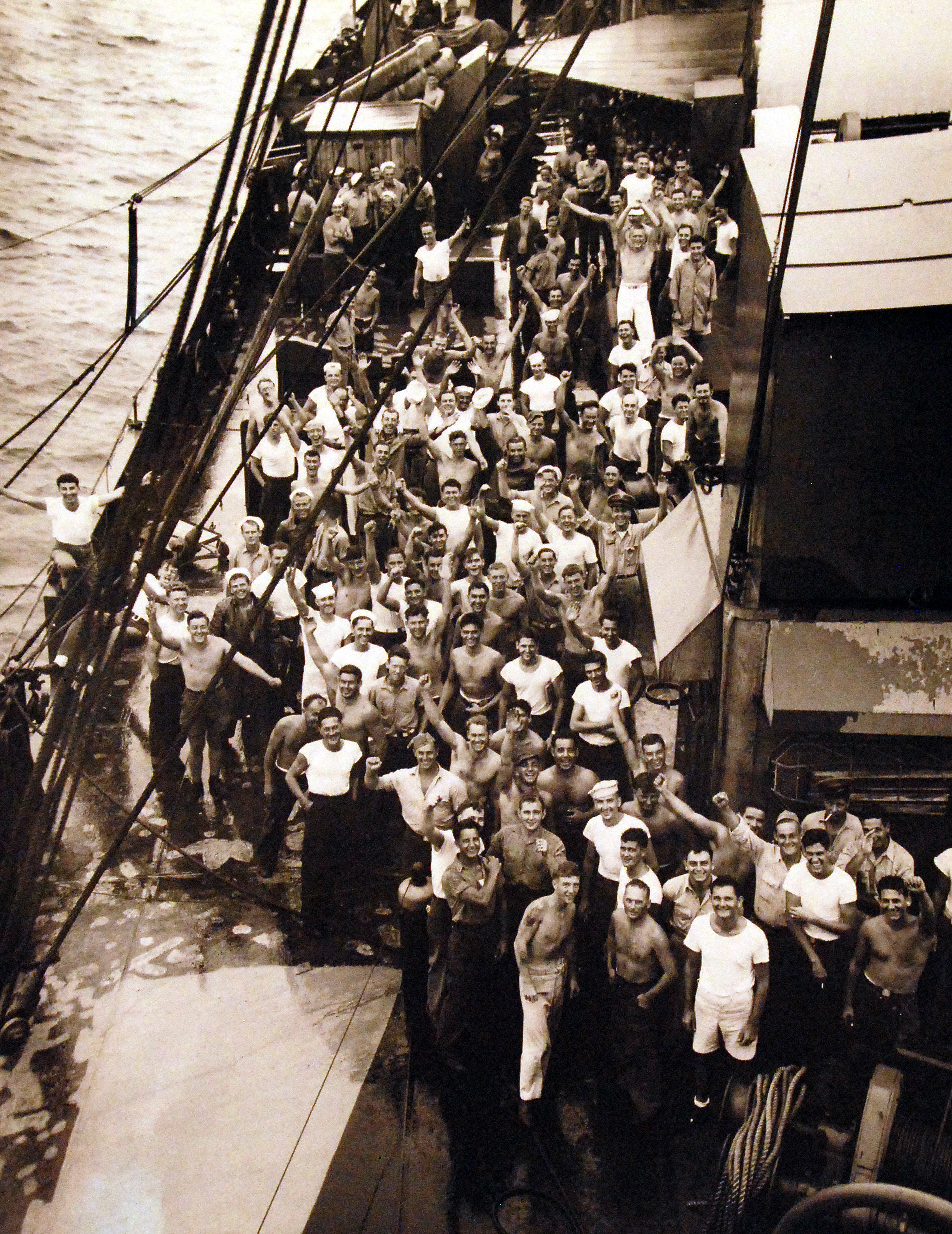 Crew of USS Oahu celebrating the news of Japanese surrender, Eniwetok Atoll, Marshall Islands, 15 Aug 1945