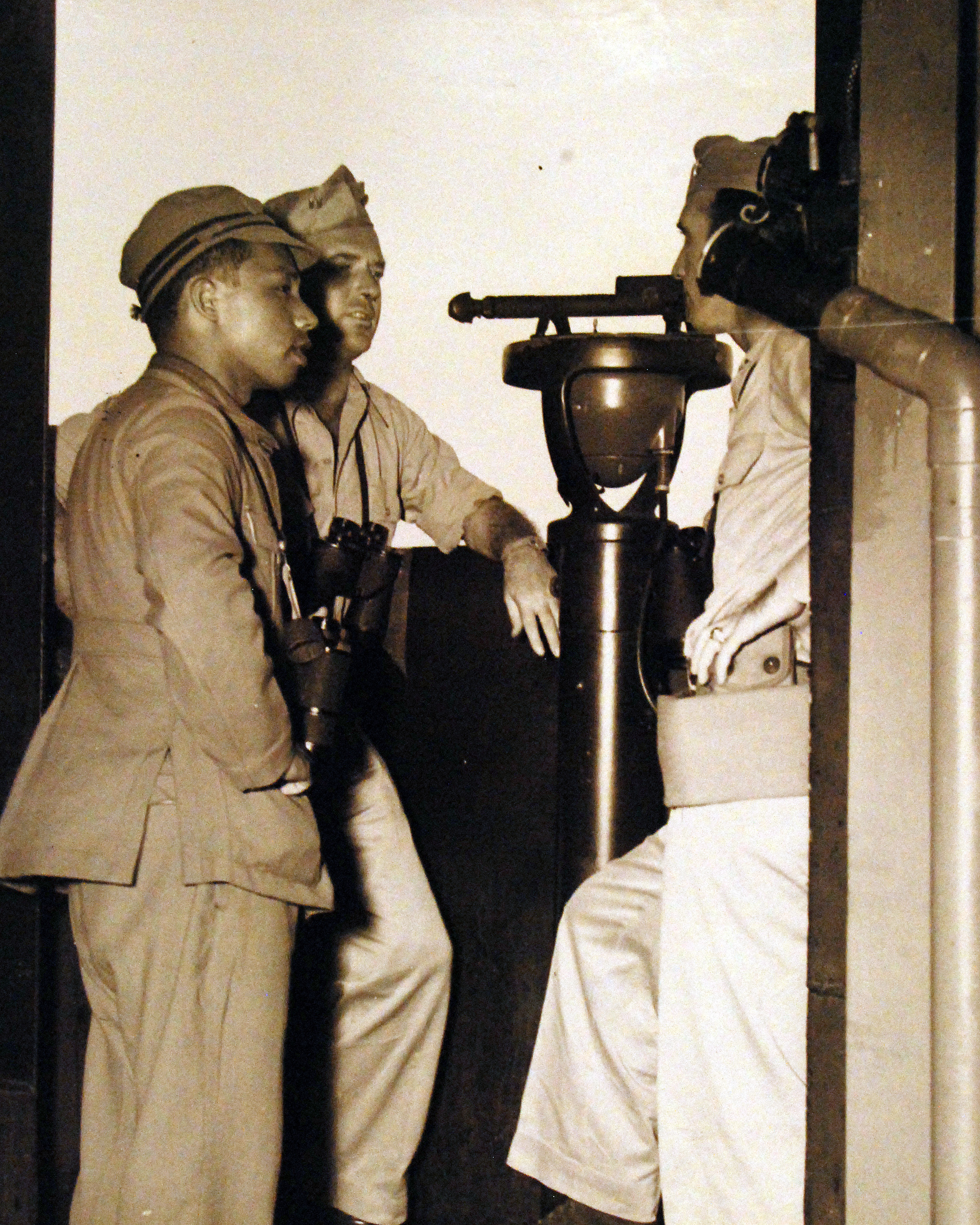 A Japanese Navy pilot speaking with Lieutenant Rogers and Lieutenant Rader of USS Cumberland Sound as the ship entered Tokyo Bay, Japan, 28 Aug 1945
