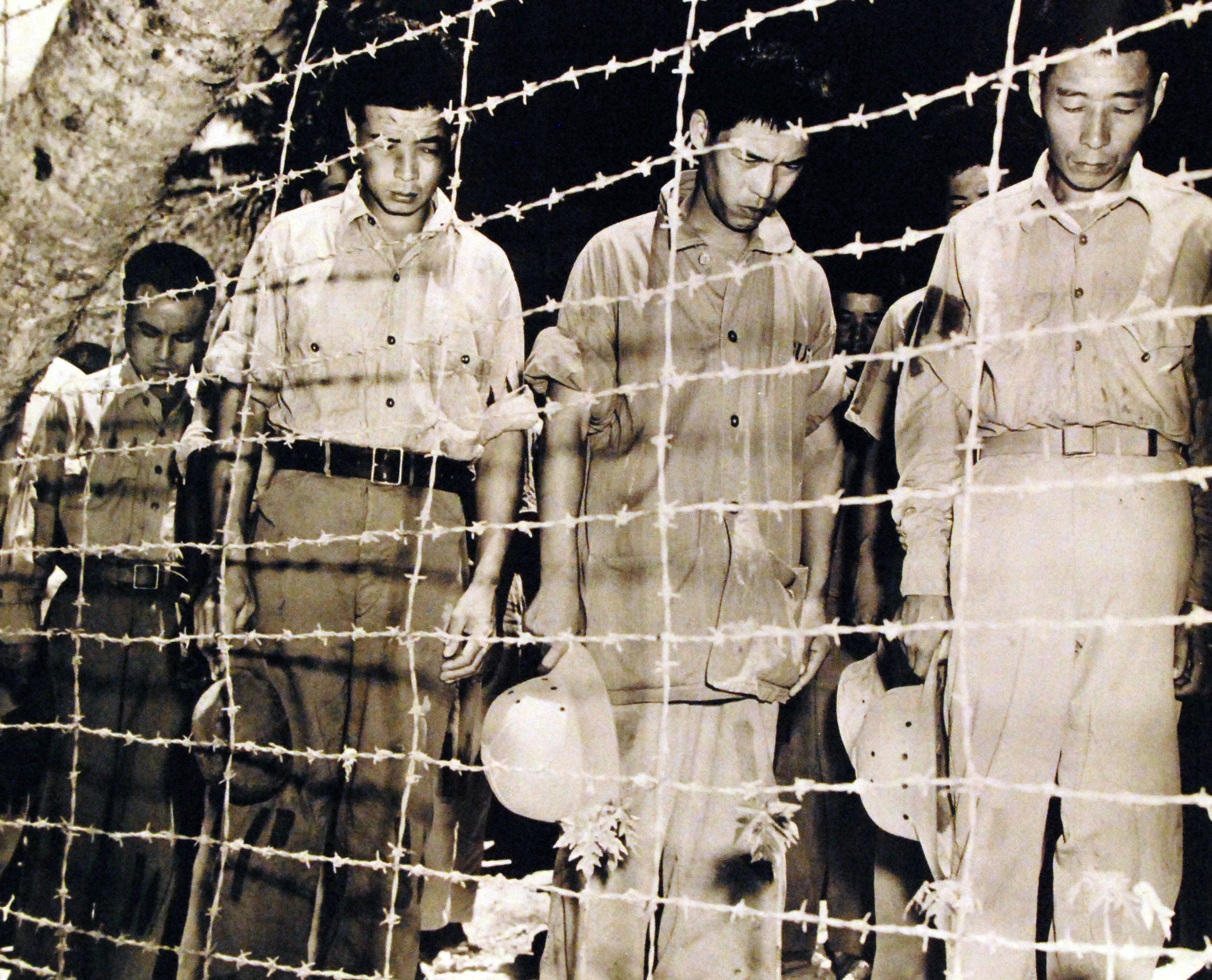 Japanese POWs at Guam bowed their heads after hearing Emperor Showa's surrender announcement, 15 Aug 1945, photo 2 of 2