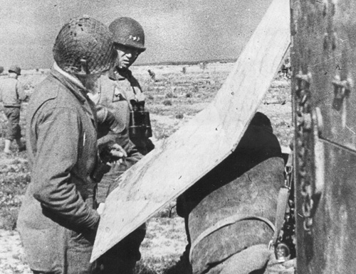 George Patton studying a map in Tunisia, spring 1943