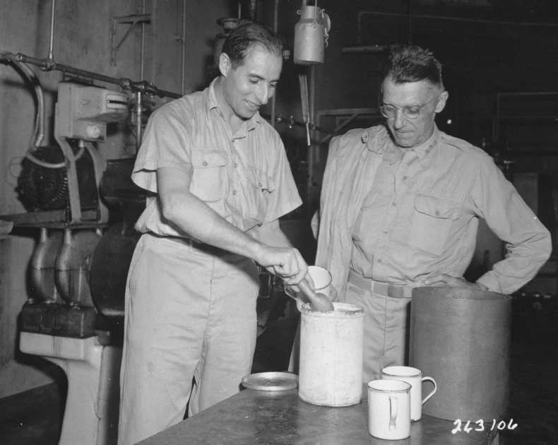 Corporal Abe Brandes serving Lieutenant General Joseph Stilwell ice cream at a US Army ice cream plant in Calcutta, India, 30 Jul 1944
