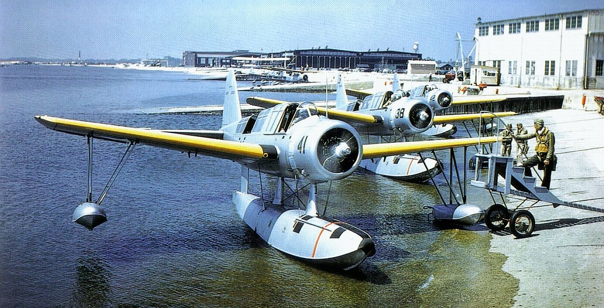 Line of OS2U Kingfisher float planes running up their engines prior to a practice flight at a training base in the United States, 1939-40.