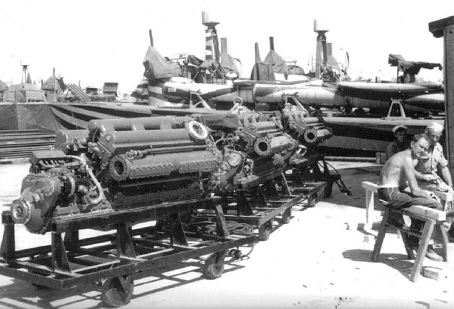 PT-208, a Higgins 78-foot motor torpedo boat in zebra paint, receiving three new Packard W-14 M2500 replacement engines at Bizerte, Tunisia, 1943. Note the raised rocket launcher rails on the bow.