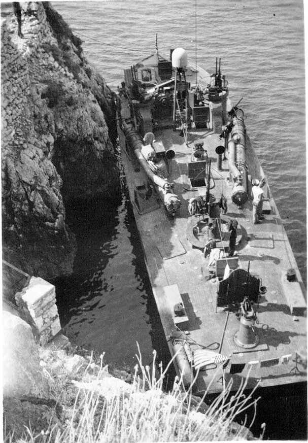 PT-215, a Higgins 78-footer of Motor Torpedo Boat Squadron 15 (MTBRon 15), tied up in Blue Grotto, Capri, Italy in Mar 1944.