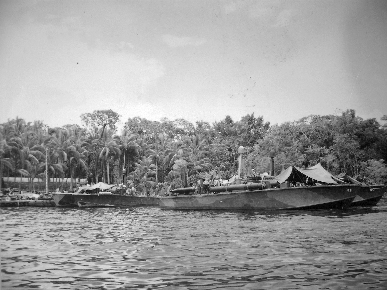 PT-183 and PT-180, Elco 80-footers of Motor Torpedo Boat Squadron 11 (MTBRon 11) at the Rendova PT Boat base on Lumbari Island in the Solomon Islands, 1944
