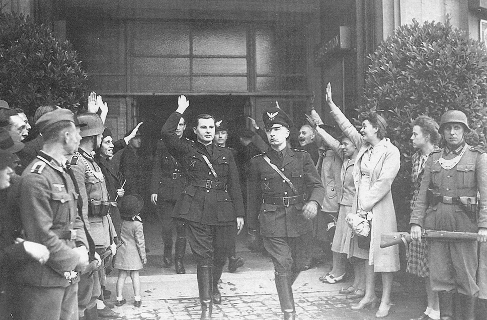 Léon Degrelle, Fernand Rouleau, and Victor Matthys (behind Degrelle) leaving the Palais des Arts at Brussels, Belgium, May 1941