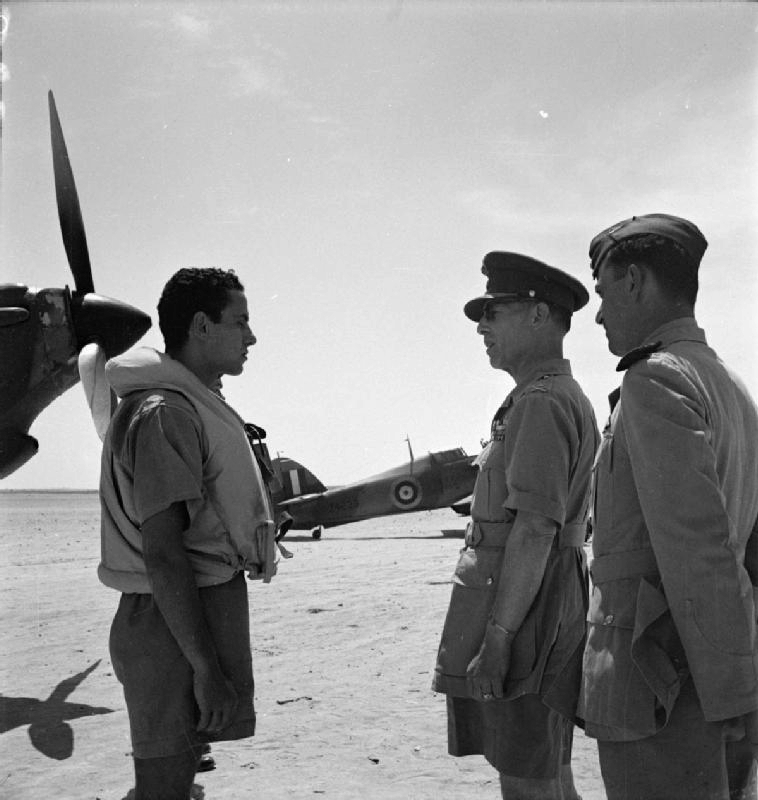 King George II of Greece speaking to a pilot of No. 335 (Hellenic) Squadron RAF at LG 20/Qotafiya, Egypt, 1942; note squadron commander Major X. F. Varvaresos