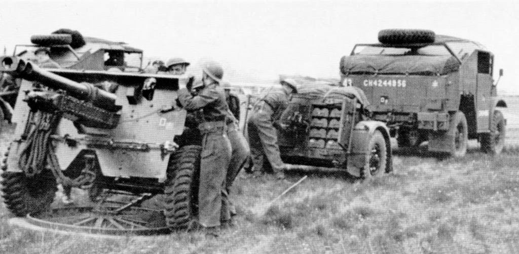 QF 25-pounder howitzer crew readying their gun, date and location unknown. Note the gun’s pedestal floor plate, the ammunition packed in the limber, and the CMP Field Artillery Tractor.