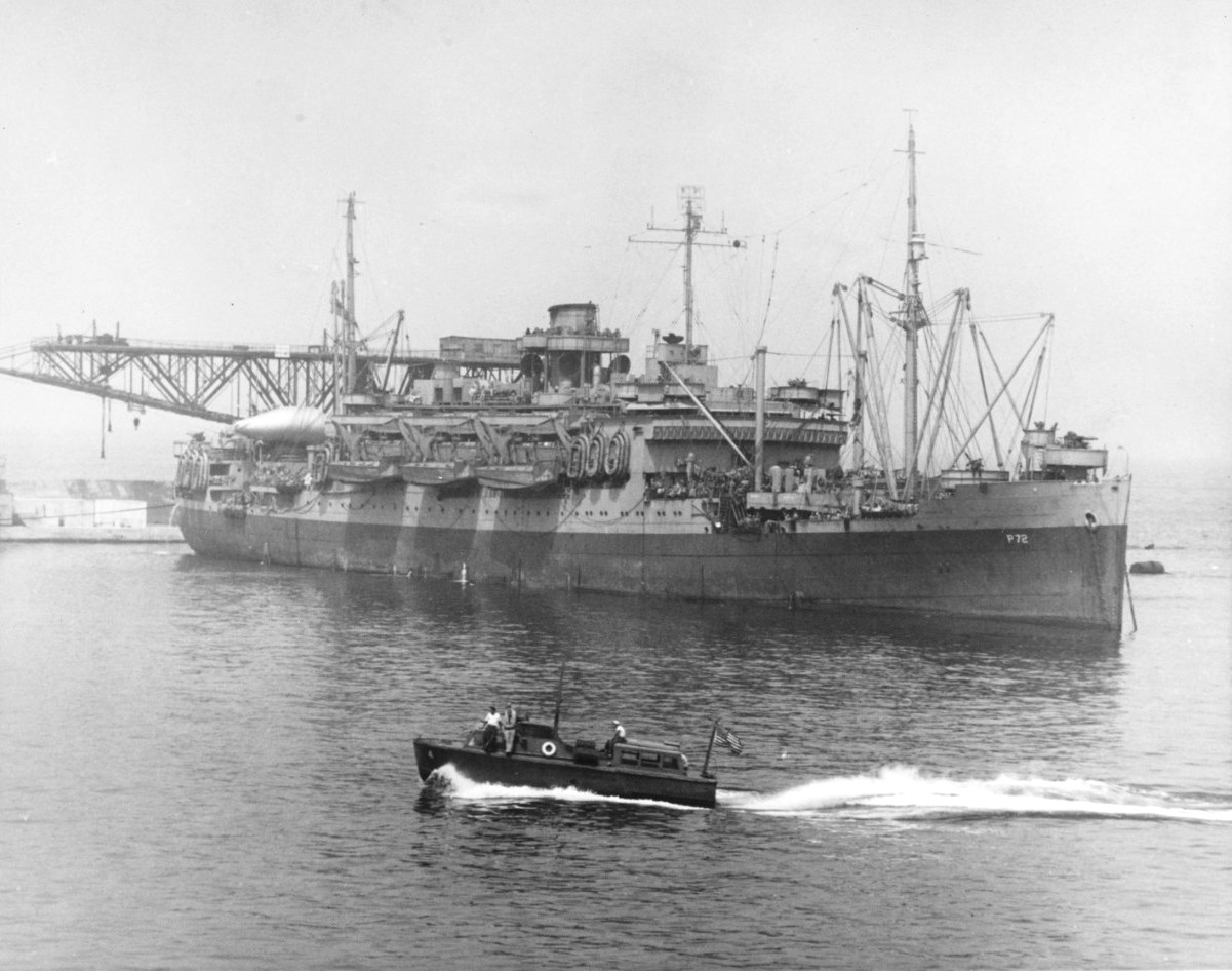 Troop transport USS Susan B. Anthony (converted luxury liner) in Mers-el-Kebir, Oran, Algeria preparing for the invasion of Sicily, 5 Jul 1943. Note LCVP landing craft hanging from her davits and stowed on her foredeck.