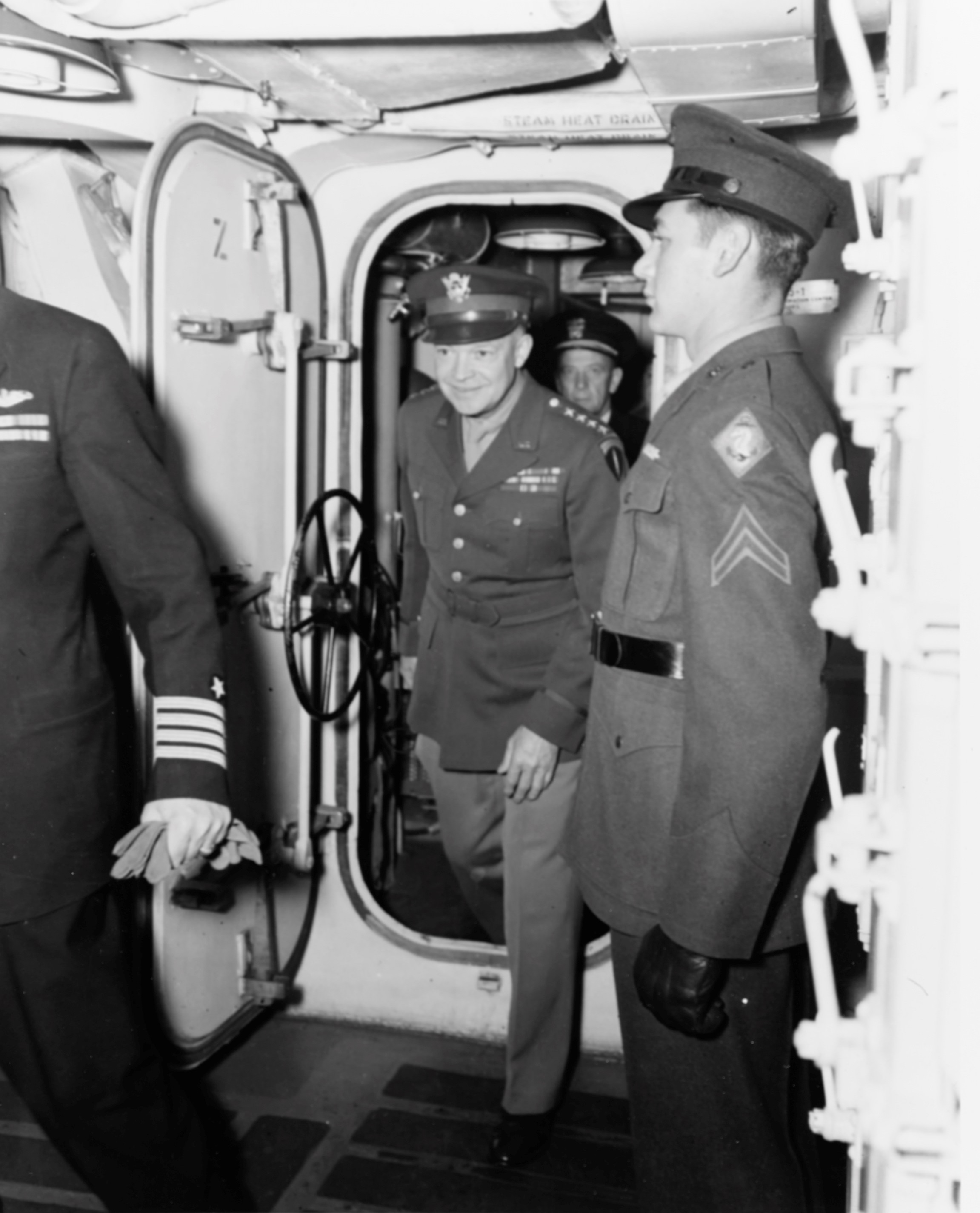 General Dwight Eisenhower making an inspection visit aboard the cruiser USS Quincy (Baltimore-class) at Belfast Lough, Belfast, Northern Ireland, United Kingdom, 19 May 1944. Rear Admiral Alan Kirk is behind him.