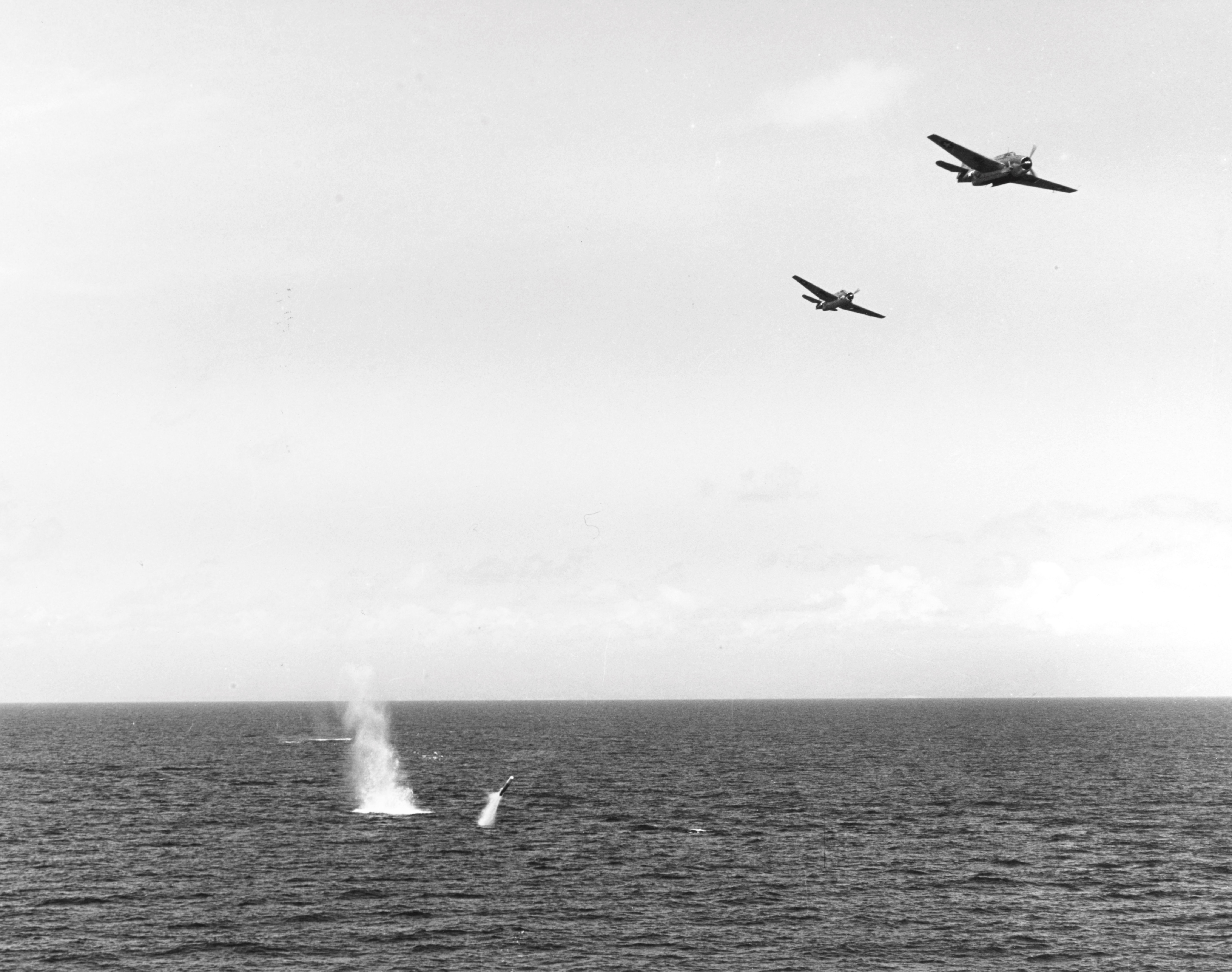 TBF-1 Avengers from the Carrier USS Essex dropping a practice torpedo from 150-200 feet, Gulf of Paria, Trinidad, 30 Mar 1943.  Note the porpoising early Mark XIII torpedo.
