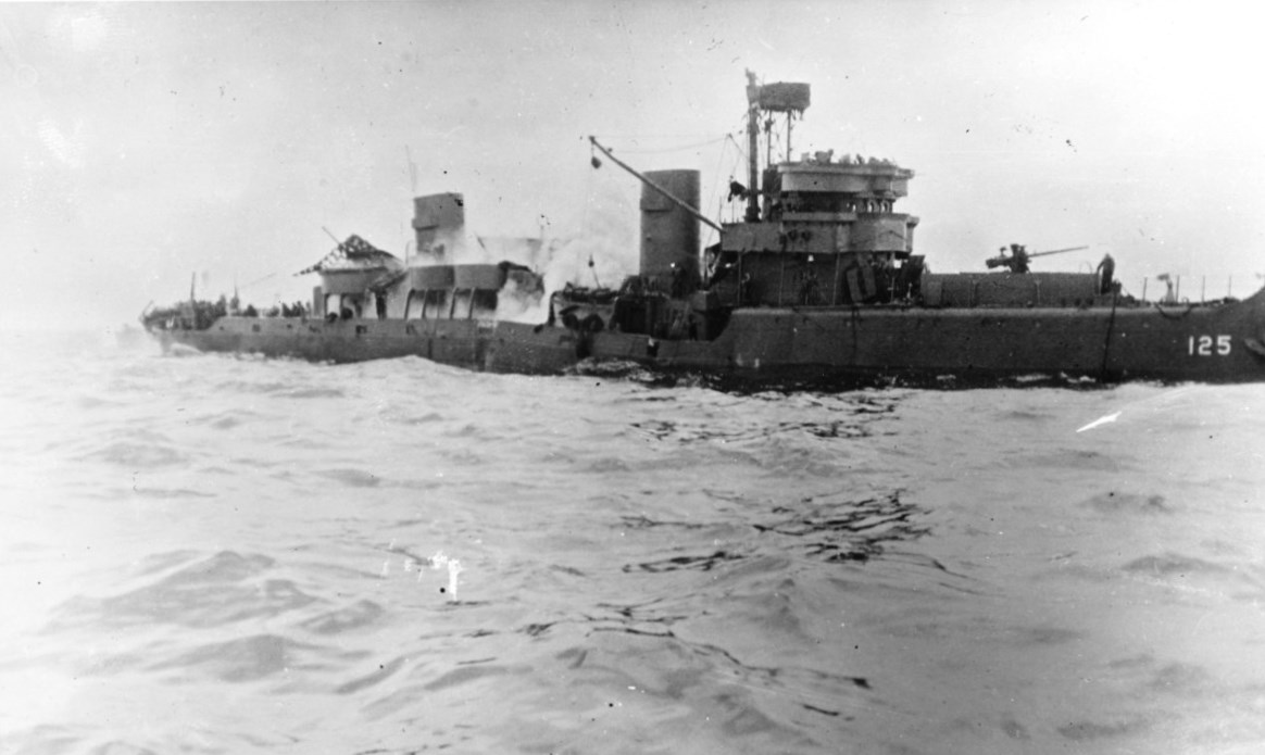 Minesweeper USS Tide with her back broken and sinking after triggering a magnetic mine off Utah Beach, Normandy, France, 7 Jun 1944.
