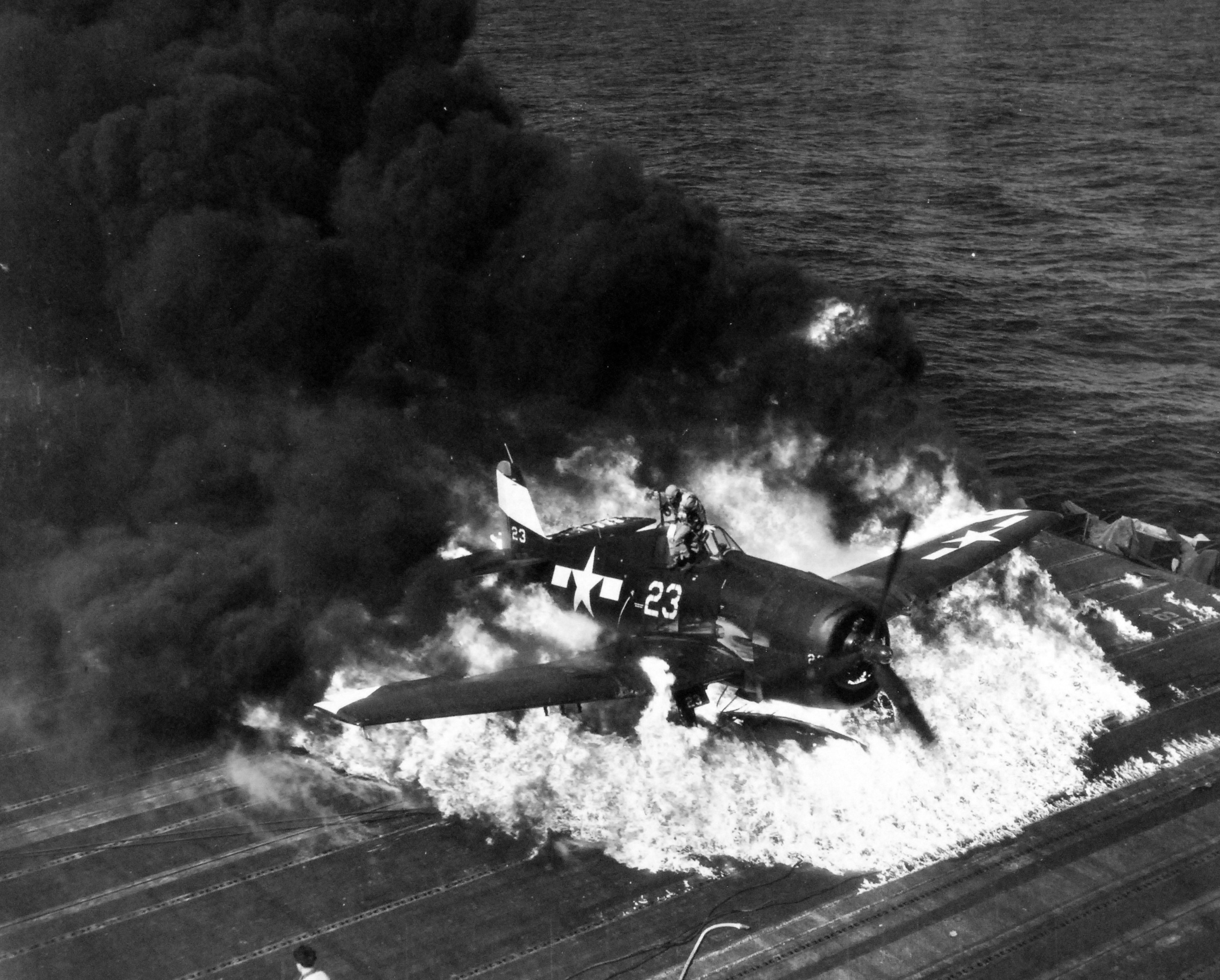 Ensign Ardon R. Ives of Fighting-Bombing Squadron VBF-9 crashed his F6F-5 Hellcat through the barrier on USS Lexington (Essex-class) and ruptured the center-line fuel tank, Feb 1945, western Pacific. Photo 5 of 7
