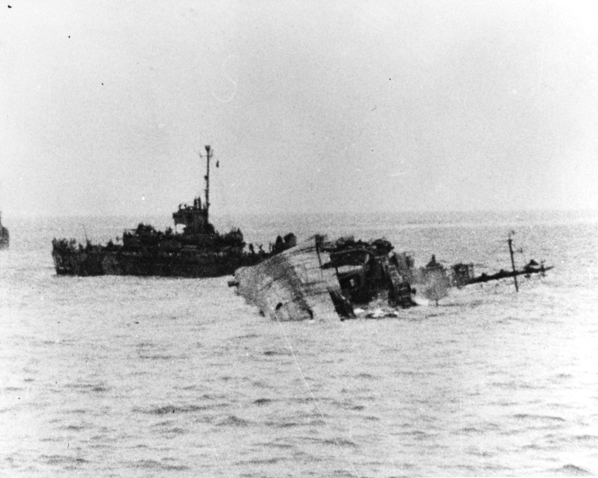 Destroyer USS William D Porter lay mortally wounded by a Japanese special attack aircraft that hit the water close aboard without striking the ship but exploded beneath the ship, off Okinawa, 10 Jun 1945
