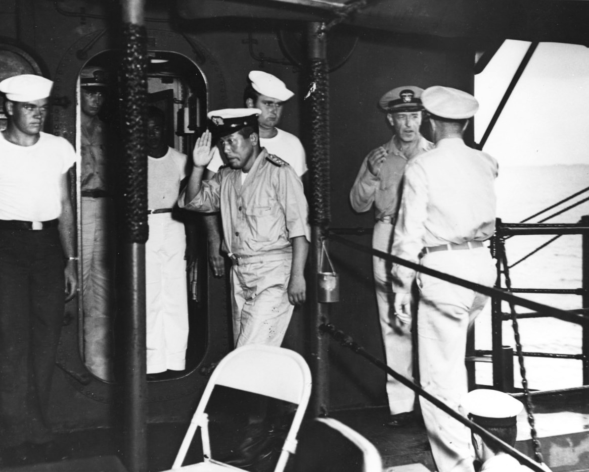Imperial Japanese Navy Captain Masanori Shiga (saluting) boarding USS Levy for the surrender signing at Mili Atoll, 22 Aug 1945. US Navy area commander Captain HB Grow stands behind Shiga.