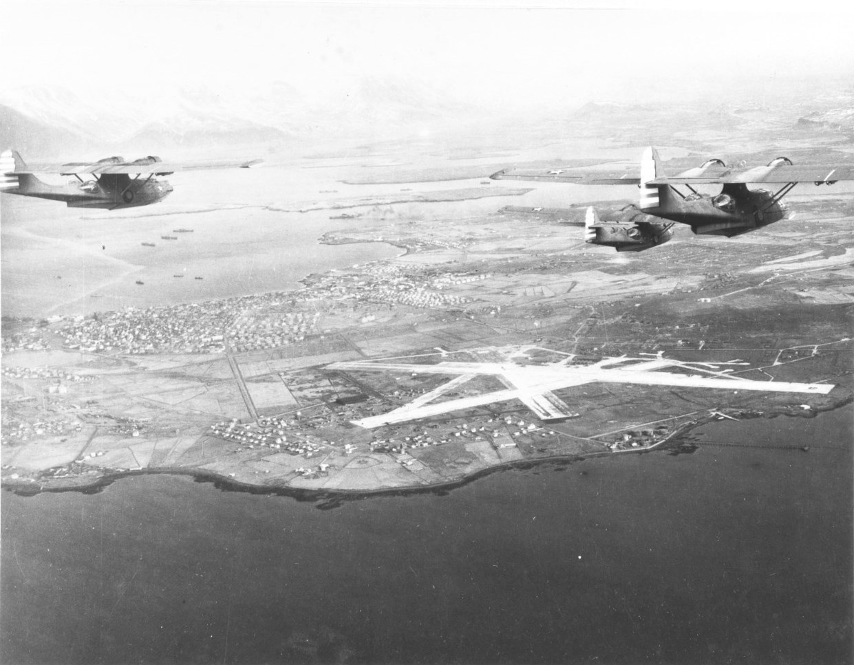 Three PBY-5A Catalinas of Patrol Squadron VP-73 approaching Reykjavík, Iceland, 23 Mar 1942. Note the red and white rudder stripes that were authorized for barely four months.