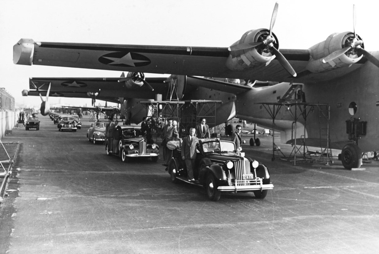 President Roosevelt (blocked from view seated in the rear seat of the lead car) tours PB2Y Coronado production at the Consolidated Aircraft plant at Lindbergh Field, San Diego, California, United States, 25 Sep 1942.