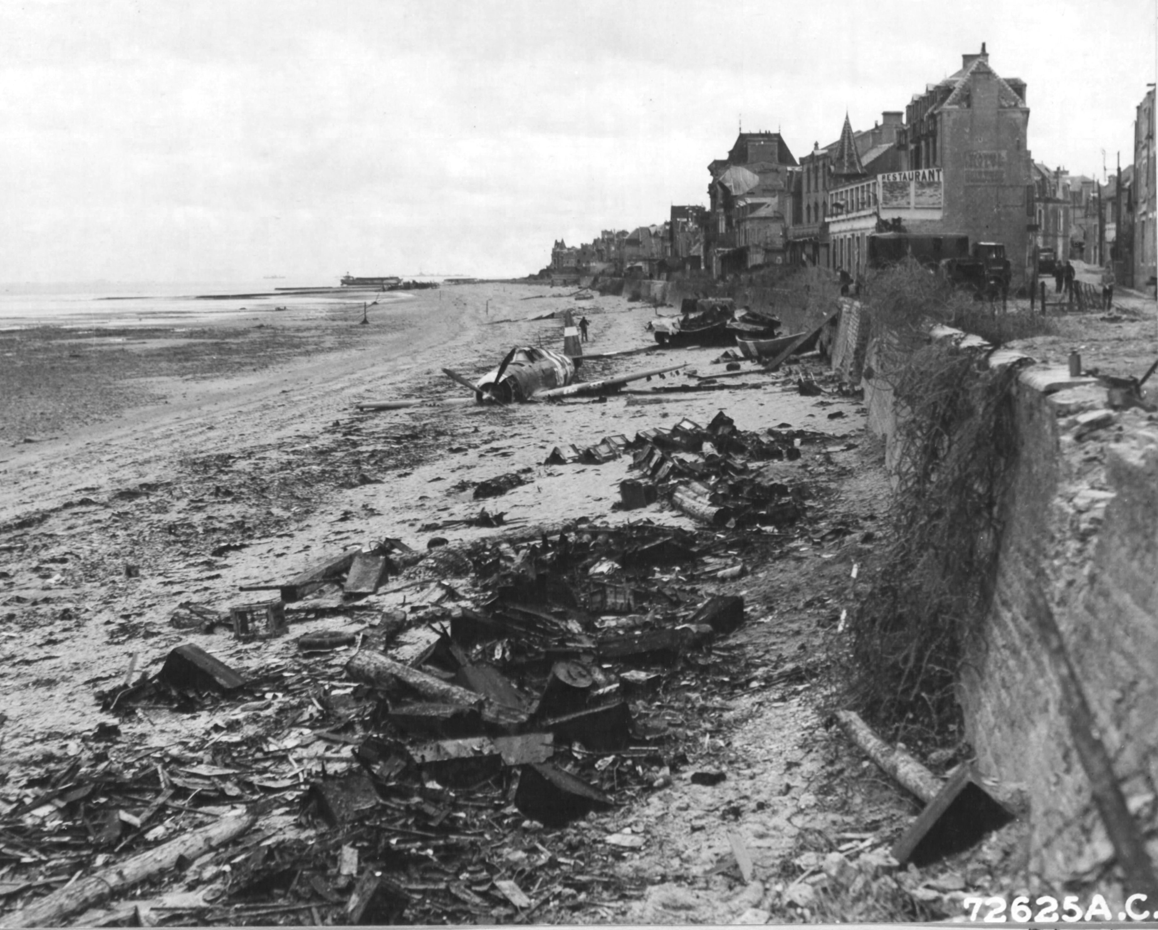 2 Jul 1944 photo of the wreckage left on Sword Beach following the D-Day landings in Normandy, France; in this case, a P-47 Thunderbolt that was shot down 10 Jun 1944 on a mission to Cherbourg, France. Photo 2 of 2.