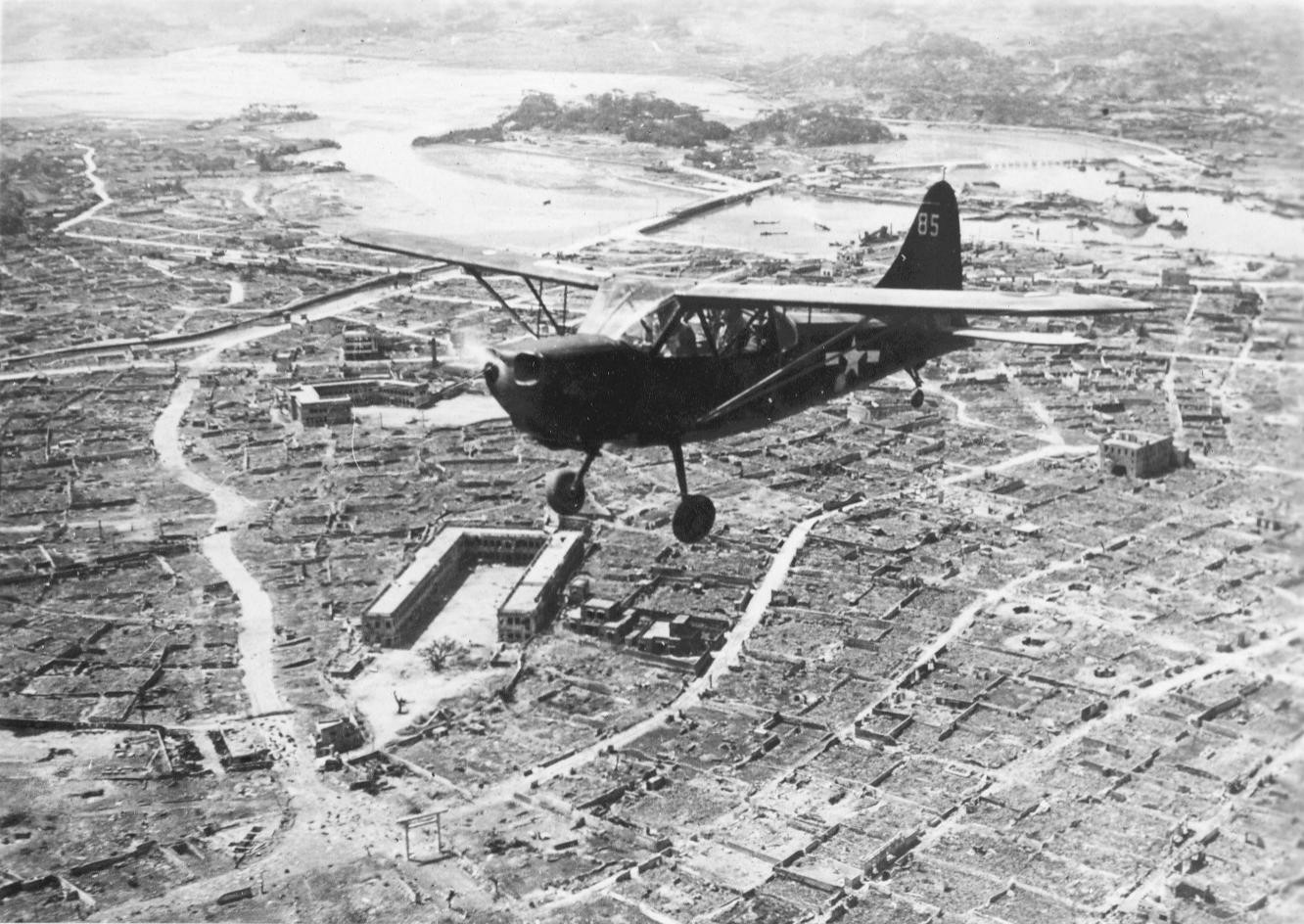 United States Marine Corps Stinson OY-1 Sentinel over Naha, Okinawa, Japan, circa Jun 1945, photo 2 of 2
