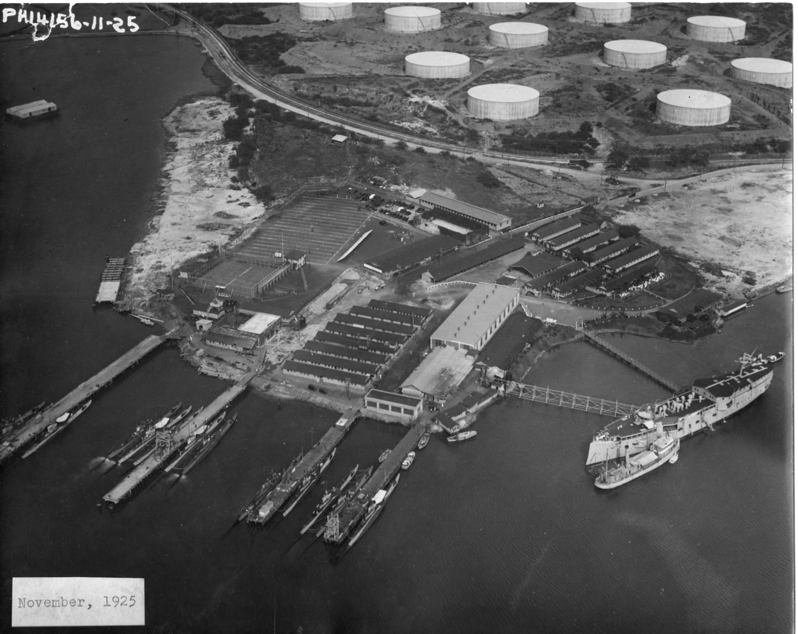 R and S class submarines at the finger piers on Merry Point at the Pearl Harbor submarine base, Pearl Harbor, Hawaii, Nov 1925. The ex-USS Chicago, converted to a barracks ship, is at right.