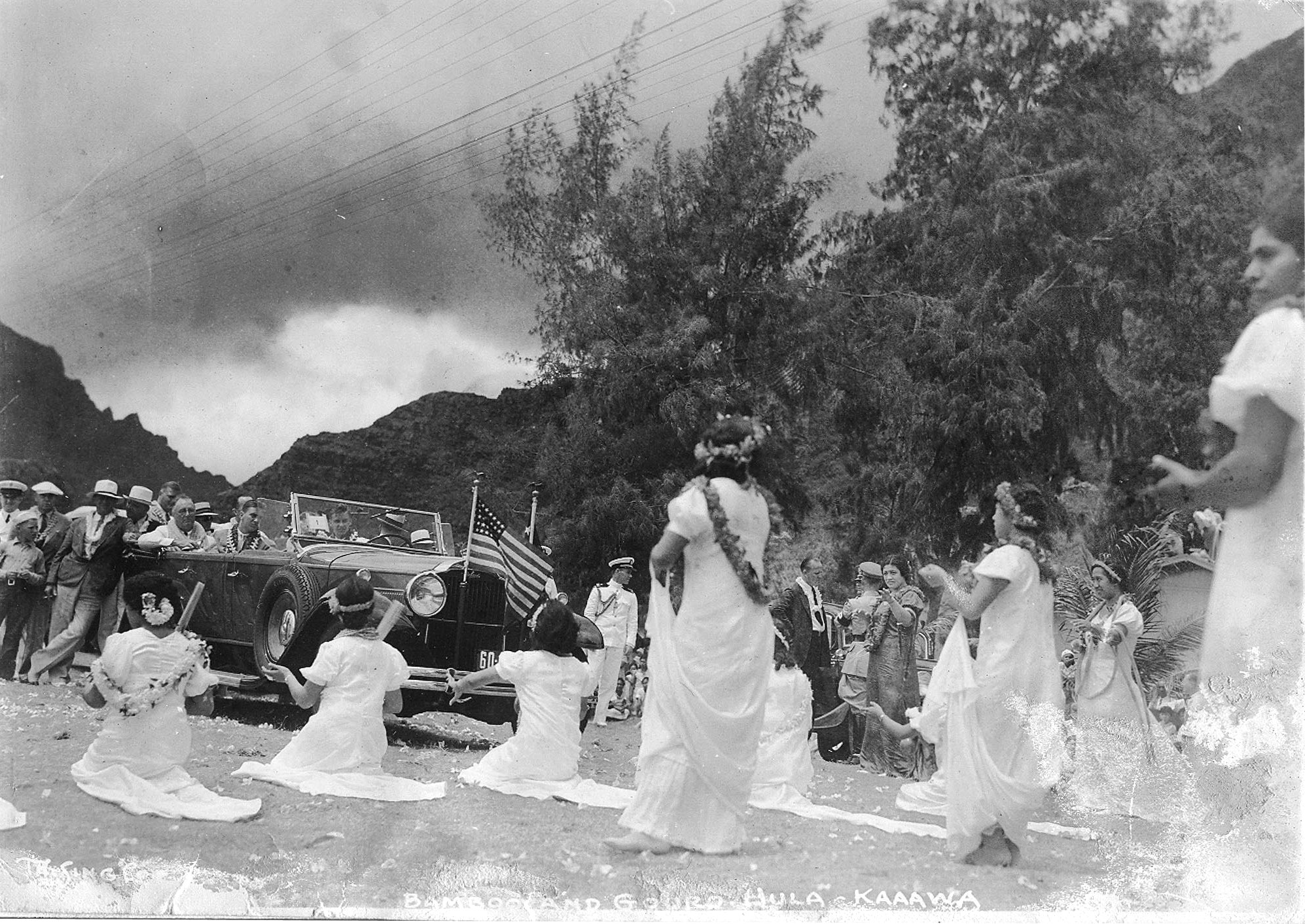 Students at the Ka'a'awa School perform the Bamboo and Gourd Hula as a welcome for President Franklin Roosevelt (seated in car) who was touring the island, Ka'a'awa, Oahu, Hawaii, 26 Jul 1934.