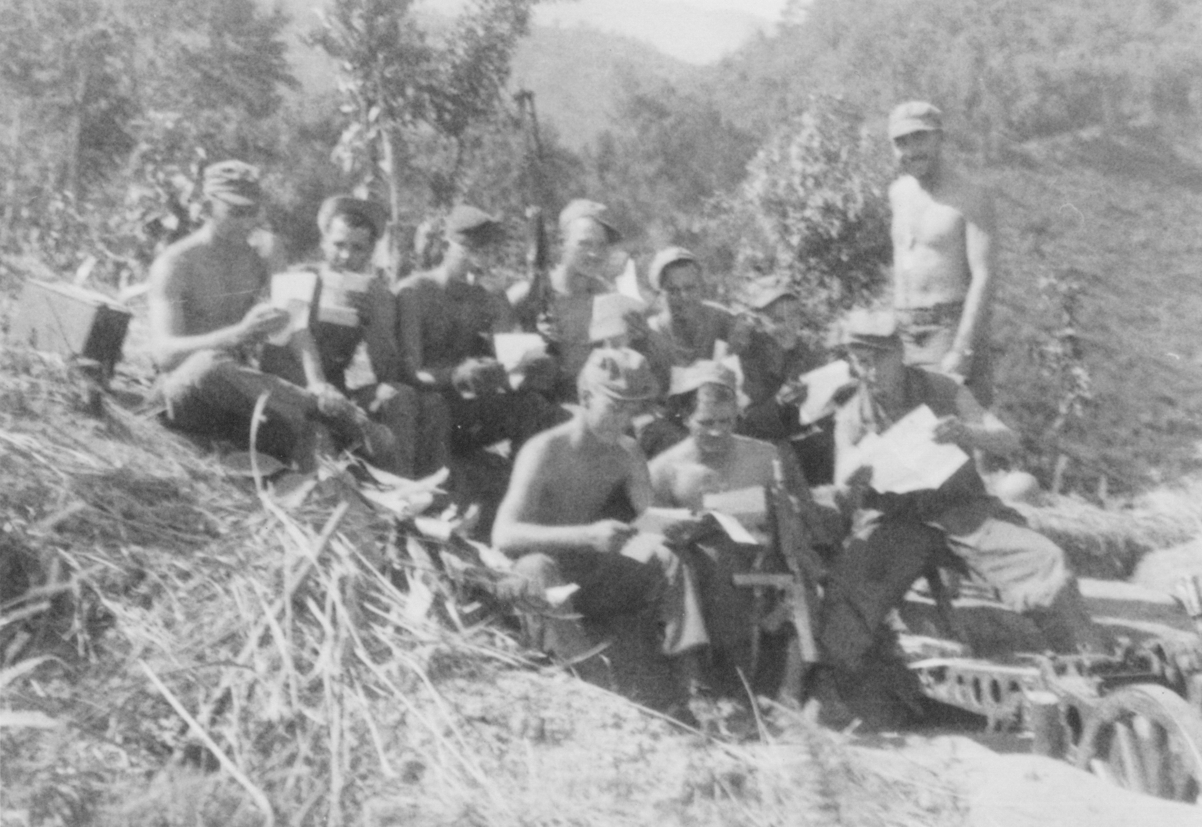 Mail call with members of US 5332nd Brigade (Provisional), probably Burma, 1945; Bartello (handing out mail), Mahl, Routson, Rokita, Frederick, and two unidentified men