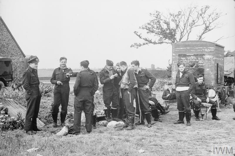 Squadron Leader J. H. Iremonger (left) and other pilots of No. 486 Squadron RNZAF at Will's Farm at RAF Newchurch, southern England, United Kingdom, Apr-Sep 1944