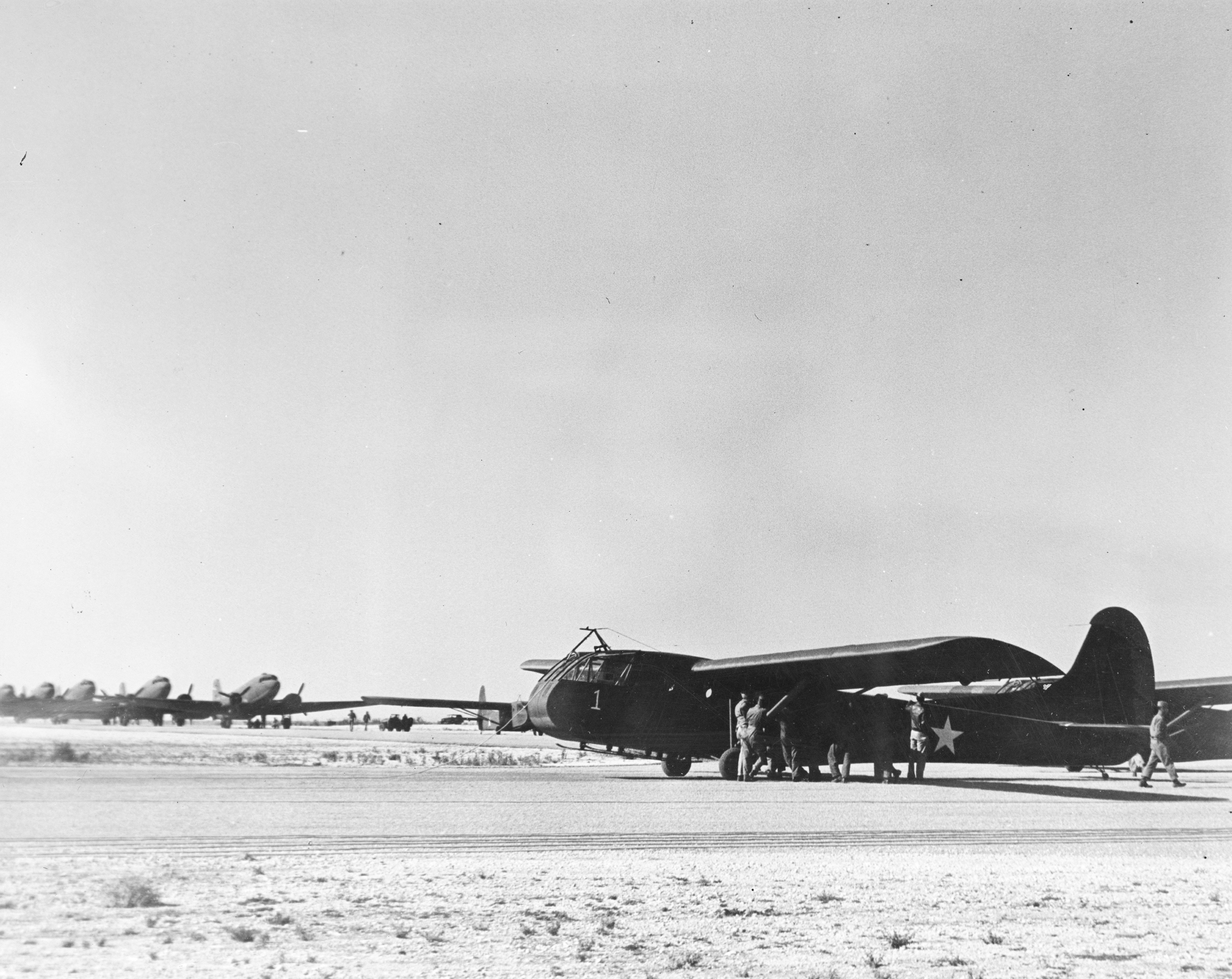 Waco CG-4A glider and C-47 Skytrains on the Big Springs Auxiliary Air Field, Big Springs, Texas, United States, 1942.