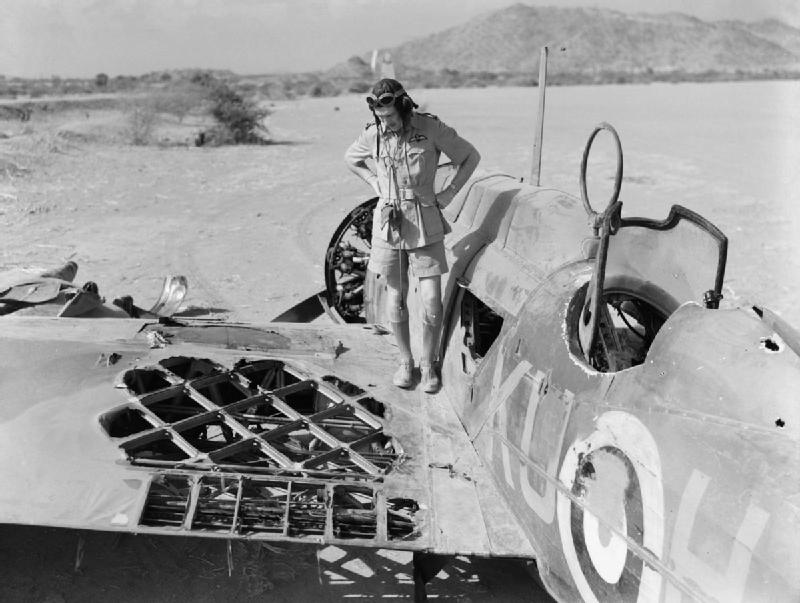 Pilot Officer Kennedy of No. 47 Squadron RAF Detachment inspecting his Wellesley bomber after engagement with two CR.42 fighters, Agordat, Eritrea, 25 Mar 1941; his gunner Sergeant German was killed